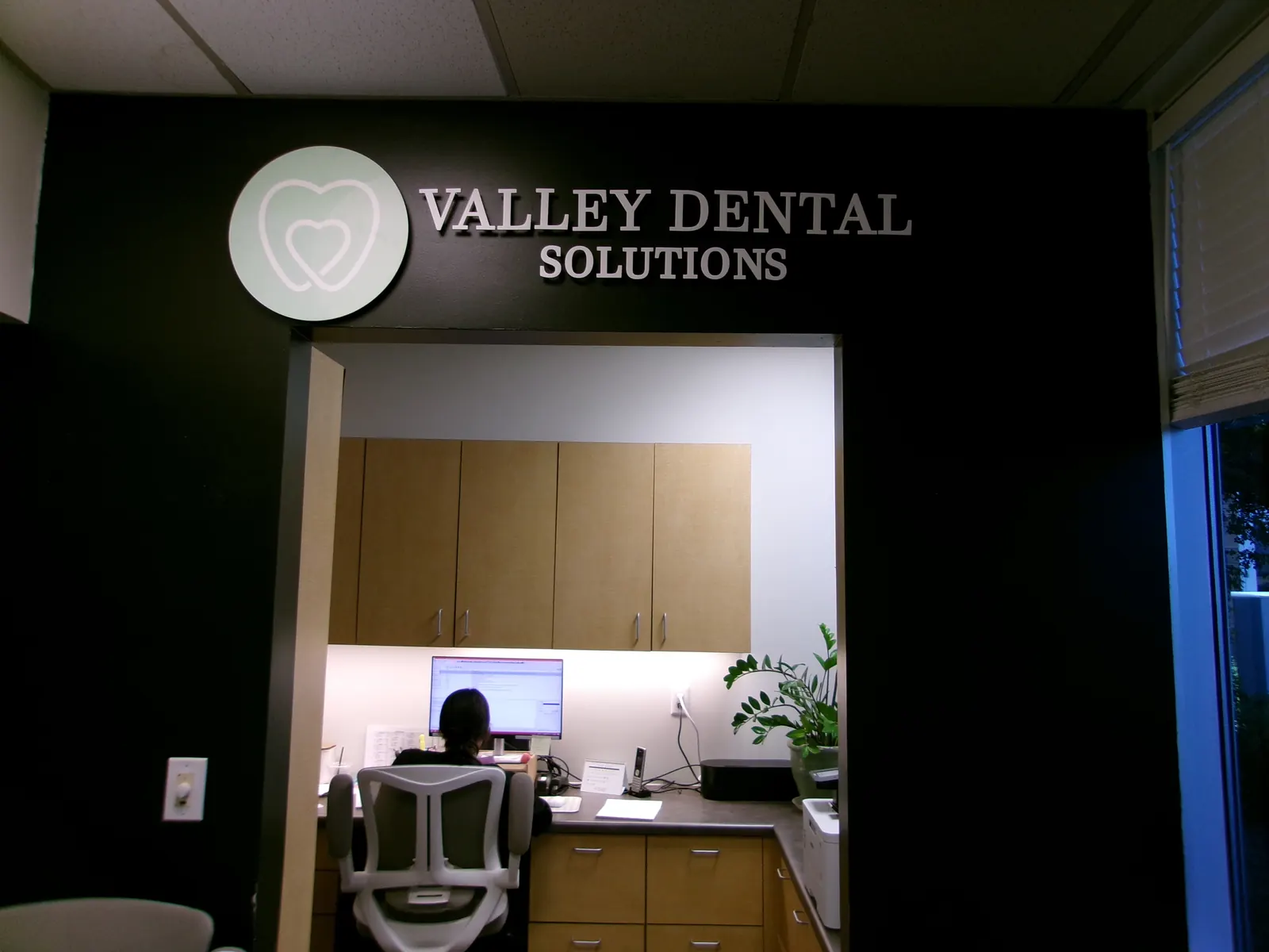 Reception desk and Valley Dental Solutions office sign in Chandler